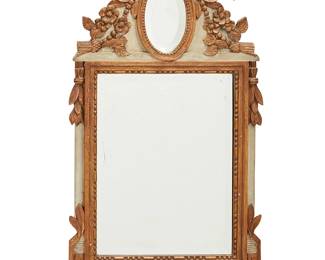 32
A Louis XVI-style paint-decorated and giltwood mirror
20th century
The beveled mirror with bead and reel trim and foliate accents, surmounted by an oval beveled mirror crested by a ribbon and floral motifs, all on a whitewashed ground
39" H x 19.75" W x 1.625" D
Estimate: $500 - $700