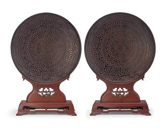 209
A pair of Chinese guri lacquer platters
Late Qing Dynasty (1644-1912)
Each with carved and enameled apocryphal reign mark for Xuande Period (1426-1435)
Each set in a carved hardwood stand
2 pieces
Each platter: 22.5" Dia. x 3" D; Each stand: 13" H x 19" W x 6" D
Estimate: $1,000 - $2,000