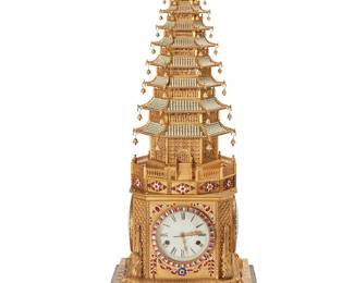 218
A rare zimingzhong automaton pagoda-form clock
Mid/late 20th century, a reproduction of the 18th century English clock made for the Chinese Qing Imperial Court now located in the Imperial Palace Museum
The two-movement clock with three dials, each bearing Roman numeral hour markers, housed in a gilt-brass case in the form of an articulated nine-tiered pagoda, adorned with cut glass jewels and cultured pearl beaded accent; when wound, the clock plays a tune and the tiers of the pagoda expand up and then contract back down
Overall: 42.5" x 17" W x 17" D
Estimate: $50,000 - $70,000