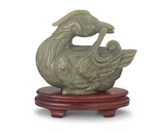 180
A Chinese carved jade figure of a duck
20th century or later
Carved in an archaistic style, set in a hardwood stand
Figure: 7.875" H x 9.5" W x 4.625" D; Stand: 2.125" H x 9.125" W x 4.875" D
Estimate: $1,000 - $1,500