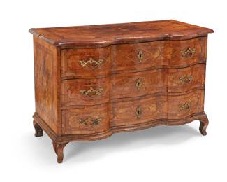 142
A German Baroque inlaid walnut commode
18th century
With serpentine front and three locking drawers, featuring inlaid trim accents and a figure to the top, raised on curvilinear legs
31.5" H x 47" W x 25" D
Estimate: $1,500 - $2,000