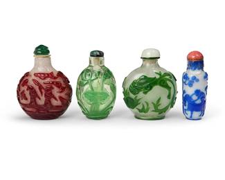 163
Four Chinese overlay glass snuff bottles
19th/20th century
Comprising one blue depicting figures riding a horse and an elephant, one red depicting figures and trees, one green depicting fish, and another green depicting flowers in a vase and set on a wood stand
4 pieces
Tallest: 3.25" H
Estimate: $800 - $1,200