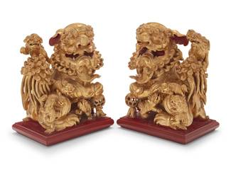 202
A pair of Chinese carved giltwood guardian lions
19th century
Each depicted with one paw holding reticulated ball and eight cubs climbing on the figure, with rectangular red lacquer bases
2 pieces
Each: 13" H x 10.25" W x 7.25" D
Estimate: $1,000 - $1,500