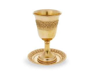 107
A 14k gold Kiddush cup and saucer
20th century
Cup marked: 14K
Each with repoussé grape motifs
2 pieces
Cup: 5" H x 2.75" Dia.; Dish: 4" Dia.
126 grams
Estimate: $5,000 - $7,000