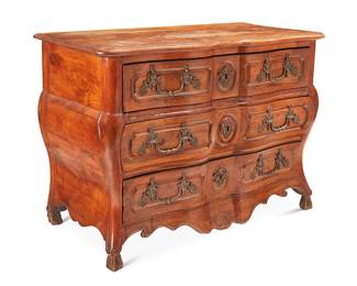 27
A Louis XV walnut bombé commode
18th century
The chest with shaped front and three locking drawers with bronze figural pulls and lock escutcheons, above an apron with scrolled and scallop shell accents
35.75" H x 49.75" W x 24.5" D
Estimate: $700 - $900