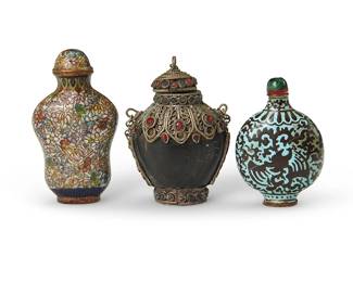 171
Two Chinese cloisonné snuff bottles and a Tibetan horn snuff bottle
19th/20th century
Comprising two enameled metal depicting floral or bat motifs, and a metal-mounted carved horn bottle with inset glass accents
3 pieces
Tallest: 2.75" H
Estimate: $500 - $700