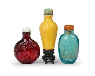 164
Three Chinese carved glass snuff bottles
19th/20th century
Comprising one blue depicting monkeys, one red depicting floral and butterfly motifs, and one yellow opaque with leaf-forms and set on a wood stand
3 pieces
Tallest: 3" H
Estimate: $400 - $600