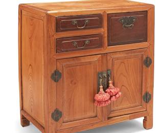 226
A small Chinese elmwood chest
Late 19th century
The chest with brass hardware, featuring three drawers, one locking with a moth-form escutcheon, above two hinged cabinet doors revealing a hollow interior
32" H x 28.25" W x 17.75" D
Estimate: $400 - $600
