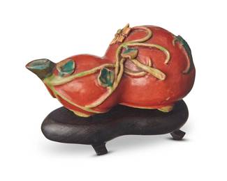 69
An East Asian polychrome enameled porcelain water dropper
19th century or later
In the form of a double gourd, set on a wood stand
Porcelain: 2.375" H x 4.75" W x 2.75" D; Stand: 1" H x 4.625" W x 2.625" D
Estimate: $800 - $1,200