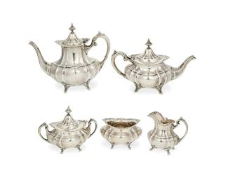 386
A Reed & Barton sterling silver 'Hampton Court' tea and coffee service
Mid/late 20th century
Each marked for Reed and Barton and for sterling, with pattern name
Comprising a coffee pot (8.75" H x 10.875" W x 5.125" D), a teapot (6.75" H x 10.5" W x 4.625" D), a lidded sugar (6" H x 7.75" W x 4.375" D), a creamer (4.875" H x 5.5" W x 3.5" D), and a cachepot (3.75" H x 5.875" W x 4.5" D)
5 pieces
Total weight: 80.2 gross oz. troy approximately
Estimate: $1,800 - $2,500