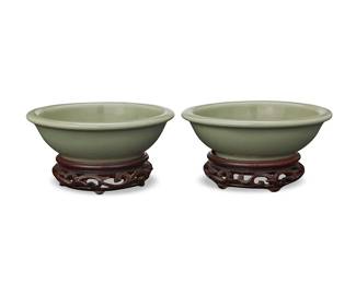 71
Two Chinese Longquan celadon bowls
Ming Dynasty (1368-1644) or later
Each with molded fish decoration to well, set on a carved wood stand
2 pieces
Each bowl: 1.875" H x 5.75" Dia.; Each stand: 1.25" H x 3.875" Dia.
Estimate: $800 - $1,200