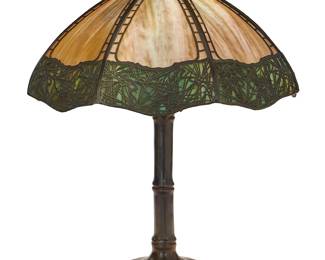 47
A Handel 'Teroca' pine needle table lamp
Early 20th century; Meriden, Connecticut
Shade aperture ring marked: Handel pat. no. 924457; base marked: HANDEL
Likely model 2489, the three-light lamp with acorn pulls, featuring a slag glass paneled shade with patinated metal overlay depicting pine needles around the border, raised on a bamboo-form patinated bronze base, electrified
Overall: 24.25" H x 19.5" Dia.
Estimate: $1,000 - $1,500