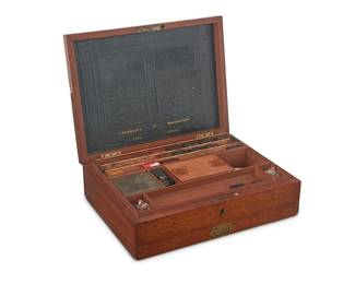302
An English watercolor artist's wood paint box
Early 19th century
Gilt-stamped to leather under lid: J. Newman's Manufactory
The locking hinged lid with tooled and gilt-stamped leather to underside, revealing multiple cubbies and lidded compartments with painting supplies and implements, all above a lower drawer with brass pull revealing an enameled metal palette
3.5" H x 12" W x 9" D
Estimate: $300 - $500