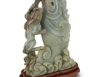 179
A large Chinese carved hardstone figure of a fish
20th/21st century
Depicted with a lion figure within roiling waves, set in a carved hardwood stand
Stone: 14.75" H 10.75" W x 4" D; Stand: 2.25" H x 12" W x 5.75" D
Estimate: $1,200 - $1,800