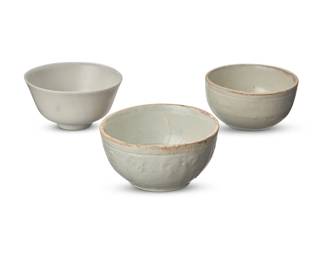 61
Three Chinese white ceramic bowls
Song/Yuan Dynasty (960-1368) or later
Footed bowl bearing a blue underglaze mark
One with molded designs to exterior
3 pieces
Footed: 1.5" H x 2.75" Dia.; Shortest: 1.625" H x 2.625" Dia.
Estimate: $500 - $700