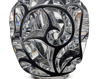 37
A Lalique black enameled glass 'Tourbillons' vase
Early 21st century
Designed 1926 by René Lalique (1860-1945)
Edition: 874/999
Etched edition and marked: Lalique ® France [post-1978]; with applied Lalique factory sticker; with Neiman Marcus retailer's sticker
With deep swirling motifs inspired by fern blossoms, housed in original box with foam forms
Vase: 8.25" H x 8" Dia.; Box: 10.75" H x 10.25" W x 10.25" D
Estimate: $1,000 - $2,000