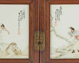 219
A Chinese Famille Rose porcelain plaque-mounted rosewood cabinet
Early 20th century
Each plaque bearing the signature and seals of Wang Qi (1884-1937)
The cabinet with brass pulls and hardware, featuring two drawers above hinged cabinet doors, each mounted with an inset porcelain painted plaque depicting warriors and tigers above a carved wood figural panel, revealing a single interior shelf
Overall: 40.75" H x 33.25" W x 20.75" D; Each plaque: 15.25" H x 10" W
Estimate: $10,000 - $15,000