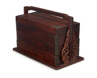 221
A Chinese hardwood picnic box
Late Qing Dynasty (1644-1912) or later
Possibly Huanghuali wood, the three stacking compartments with brass hardware, set into a handled base with openwork embellishments
9.25" H x 14.25" W x 8" D
Estimate: $2,000 - $3,000