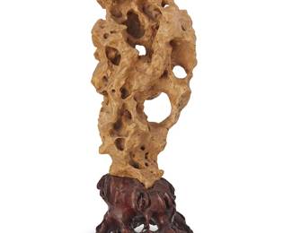 189
A Chinese Taihu scholar stone
20th century
The butterscotch stone mounted on a lacquered natural root-form base
Stone: 21" H x 9" W x 8.5" D; Overall: 26.75" H
Estimate: $2,500 - $3,000