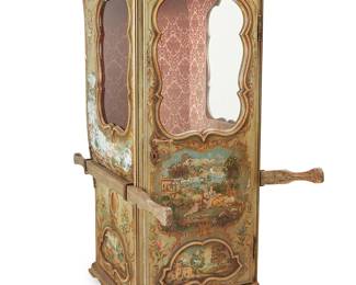 147
A Venetian Rococo-style painted wood sedan chair
20th century
The single-person cabin with a curved roof, painted with rural landscape scenes, featuring two glass windows and glazed hinged door revealing a single seat, two small shelves, and an interior lined with a faux brocade fabric, together with carrying poles
74" H x 32" W x 41" D
Estimate: $1,000 - $2,000