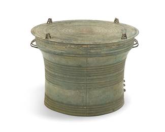 215
A Dong Son-style bronze rain drum
20th century; Southeast Asia
The stepped body with opposed handles
20" H x 26.5" Dia.
Estimate: $1,000 - $1,500
