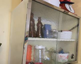 vintage chrome-trimmed metal cabinet with 2 sliding glass doors for sale! Buyer must remove, but only attached with 4 screws
