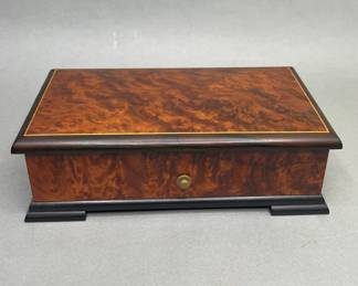 Vintage Reuge Burlwood Walnut Music Box. Plays the Thieving Magpie from the Rossini’s La Gazza Ladra Made In Sainte-Croix, Switzerland h: 3 x w: 9 x d: 5 inches
CONDITION: does not play; the works need repair