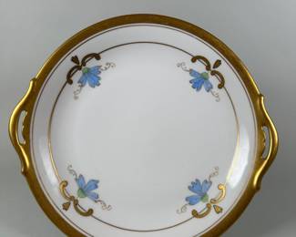W.A. Pickard (Chicago) Hand Painted Nippon (Japan) Two Handled Porcelain Dish, circa 1910s/20s, the porcelain dish with gilt rim and handles, hand painted with four blue flowers highlighted in gilt, Diameter: 10 1/2 inches