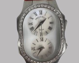 Philip Stein "Teslar" Diamond And Stainless Steel Women's Wrist Watch, the oblong case with two mother of pear dials, with roman numerals, two crowns, with 47 diamonds around bezel, on red patent leather strap, Dial Dia: 1 inch, Length overall: 8 1/2 inches.
CONDITION: wear to strap, light wear to case from use.