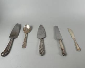 Five American Sterling Silver Serving Utensils With Stainless Steel Blades, Gorham And Whiting. Fish Knife: Length: 7 1/4 inches, Ornemental Curved Serving Spoon: Length: 7 inches, Serrated Rounded Cake Server with Stainless Steel Blade and Sterling Handle: Length: 9 1/2 inches, Hunt and Silver Co. Stainless Steel Blade and Sterling Handle Serrated Serving Knife: Length: 10 1/4 inches, Rounded Cake Server with Stainless Steel Blade and Sterling Handle: Length: 9 3/4 inches