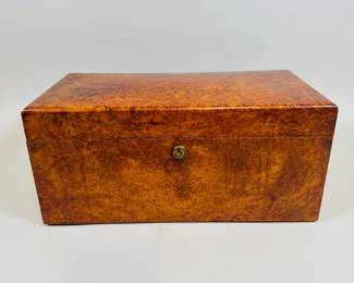 Tiffany & Co. Burl Wood Humidor, C. Late 19th Century. H: 5 1/2 x w: 12 1/2 x d: 6 1/2 inches
CONDITION: crack inside lid at upper left corner, small chip to wood at rear left corner, scattered minor finish loss, interior parts are intact and overall in very good condition