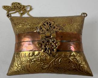 Vintage Brass And Copper Pillow-Form Evening Bag. With embossed floral designs, pierced brass clasp, mesh handle, red velvet interior, H: 2 inches x w: 4 1/2 inches