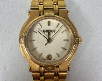 Vintage Gucci Gold Plated Women's Wrist Watch, circa 1980s/90s, with gold plated strap and case, white dial with GG bezel, quartz movement, reference 9200L, Dial Dia: 1 inch, Length overall: 6 1/4 inches.
CONDITION: very good, little sign of use or wear.
