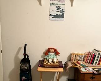 vacuum, vintage toys, shelf, games and fold out table.