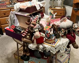 closer up of Christmas items, vintage toy train, vintage baby clothes, hankies, touch lamps in back and more