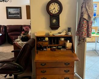 vintage fold down top desk, clock, some aprons, office chair, office supplies and more