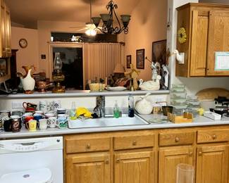 home decor, lots of mugs, vintage cups like koolaid, crayola and glass food storage containers.