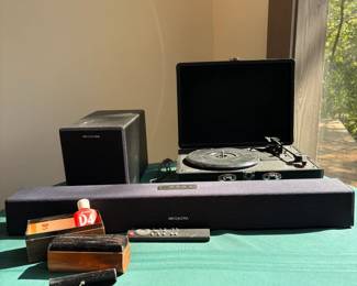 Megacra soundbar & wired subwoofer; portable suitcase-style record player. Has Bluetooth capability