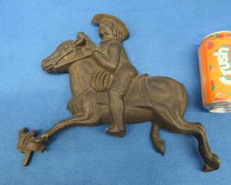 Lot 203. Cast iron decorative horse and rider. Some damage.