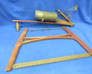 Lot 209. Antique seed planter and a bucksaw