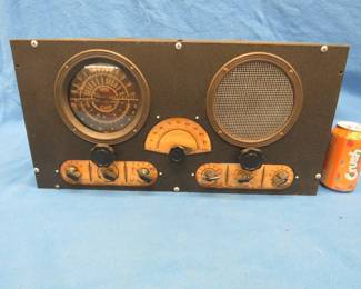 Lot 317. Late 1930s Raco Super Clipper radio in an all metal case. Includes headphones. Untested due to frayed cord.