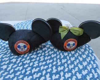 Lot 151. Two vintage Mickey Mouse Disneyland ears, baby shoes, and a box of ribbons