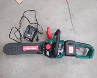 Lot 186. 40 volt Hychika chainsaw. Includes two batteries and a charger. Works good. Oil reservoir has a leak.