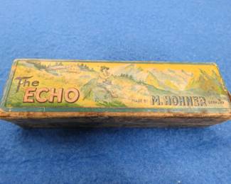 Lot 155. Hohner Echo diatonic harmonica in the key of B flat in the box. Sounds great, some rust. Box in fair condition
