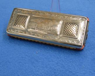 Lot 300. Eagle Brand double-sided 64-reed tremolo harmonica in the key of G. Sounds great. Box in fair condition.