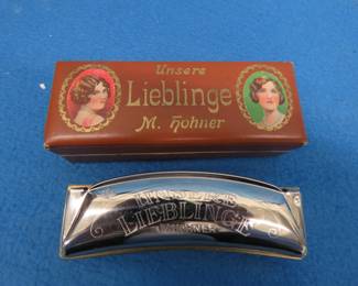Lot 67. Hohner Unsere Lieblinge (Our favorite) 28-hole octave harmonica in the key of G, sounds great. Box in VGC