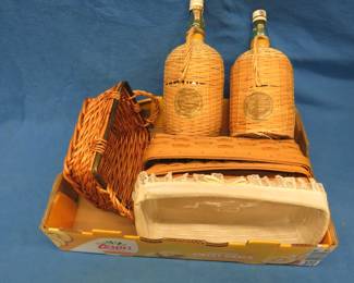 Lot 313. Two wine bottles wrapped in wicker and four wicker baskets
