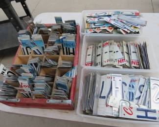 Lot 51. Vintage wooden Coke tray and three more containers of cut up license plates ready for your crafting creations.