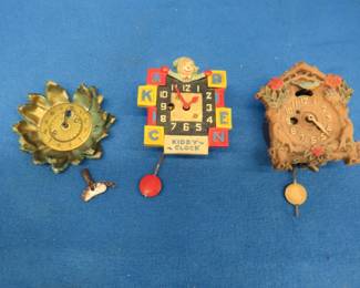 Lot 207. Two vintage clocks for parts or repair. Sunflower clock face.