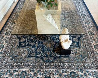 Area rug and glass top coffee table